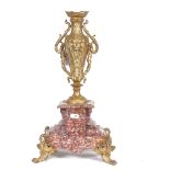 An Art Nouveau gilt-brass and veined red marble urn, on scrolled acanthus feet, overall height 44cm