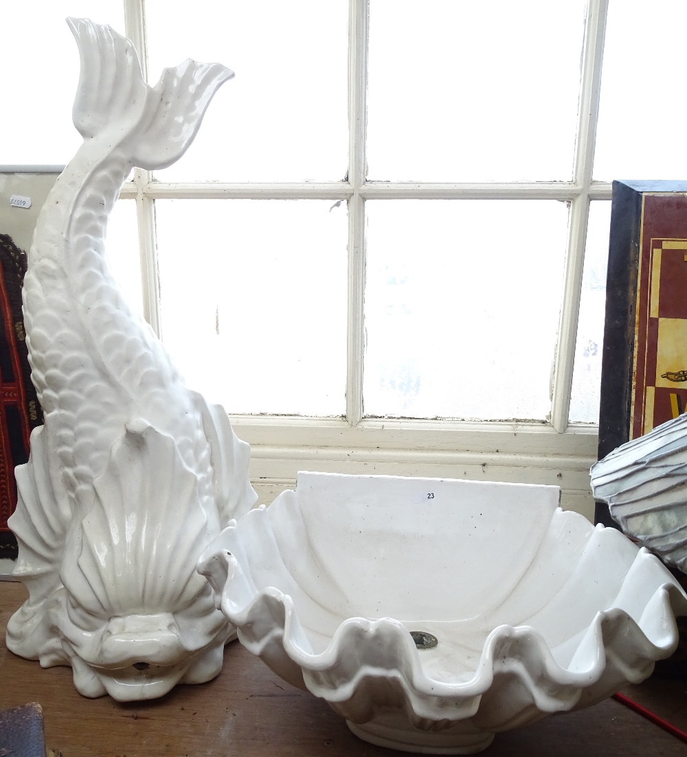 A large white painted ceramic dolphin water fountain spout and matching clam shell basin, dolphin