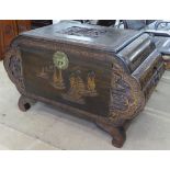 A Chinese camphorwood blanket chest, of shaped form, with relief carved decoration, on scrolled