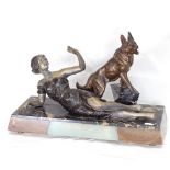 An Art Deco spelter sculpture depicting reclining lady and Alsatian, on bevelled rectangular