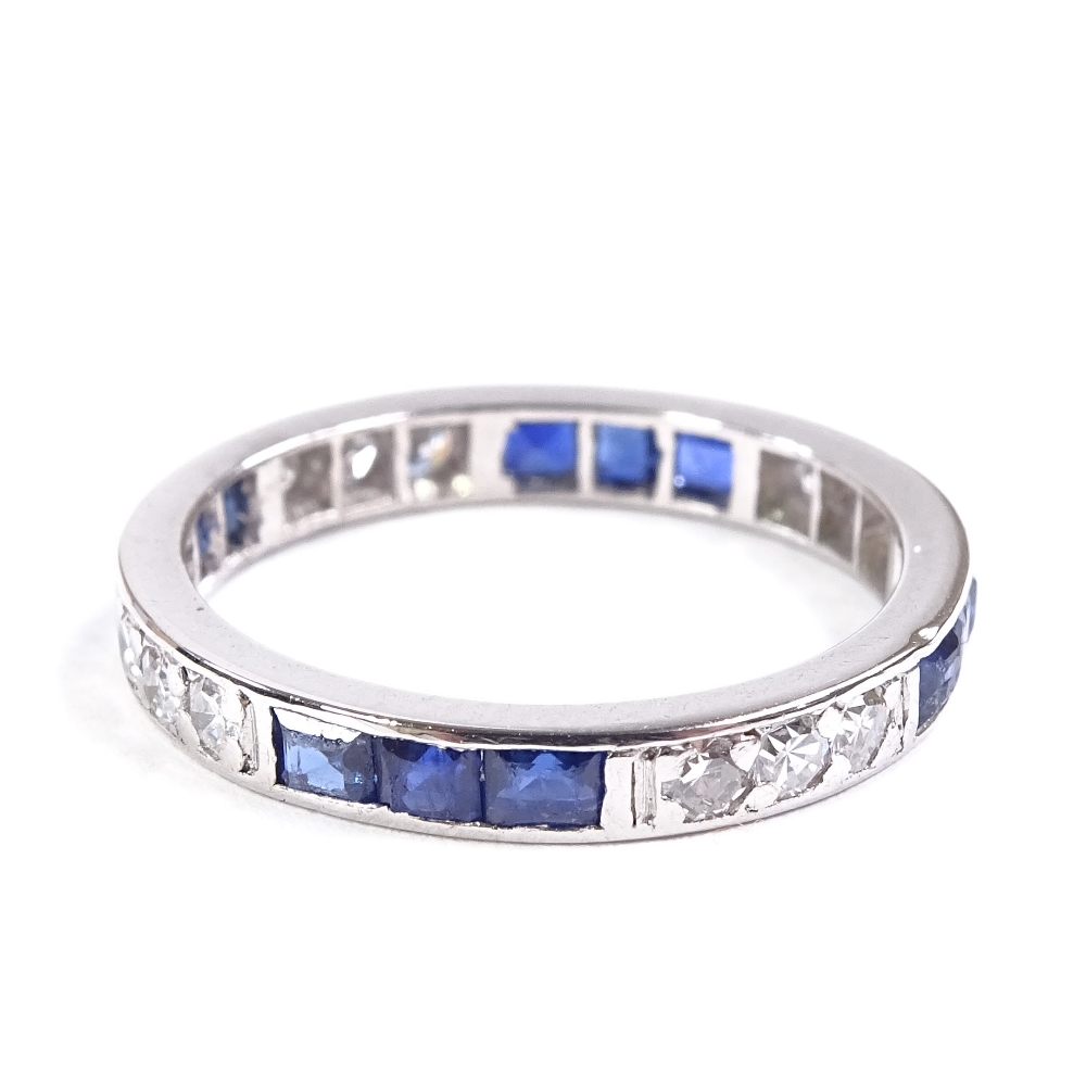 An unmarked platinum sapphire and diamond eternity ring, alternating trios of square-cut sapphires - Image 2 of 4