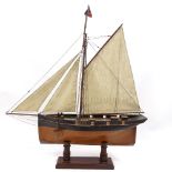 A Victorian painted wood hulled model pond yacht, with sales and rigging, hull length 57cm, on