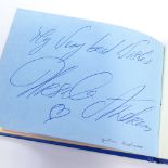 An autograph book, including original signatures by Muhammad Ali, Gene Kelly, Charlton Heston,