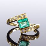 An 18ct gold emerald and diamond crossover dress ring, maker's marks JWJ, hallmarks London 1990,