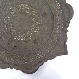 An Islamic pierced and engraved copper tray, early 20th century, 35cm across
