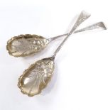A pair of late Victorian silver berry spoons, Old English pattern with gilt engraved and embossed