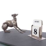 An early 20th century silver-mounted slate desk stand, surmounted by a dog and perpetual calendar,