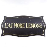 WITHDRAWN A black and gilt glass shop display plaque "Eat More Lemons", 78cm x 40cm