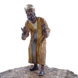 A large cold painted metal sculpture of an Arab carpet seller, stamped made in Austria, height 18cm