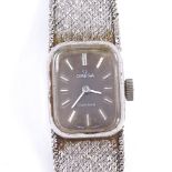 OMEGA - a lady's Vintage 9ct white gold Geneve mechanical wristwatch, ref. 1061, black dial with