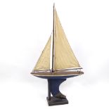 A Victorian painted wood hulled model pond yacht, with sails and rigging, hull length 16cm, height