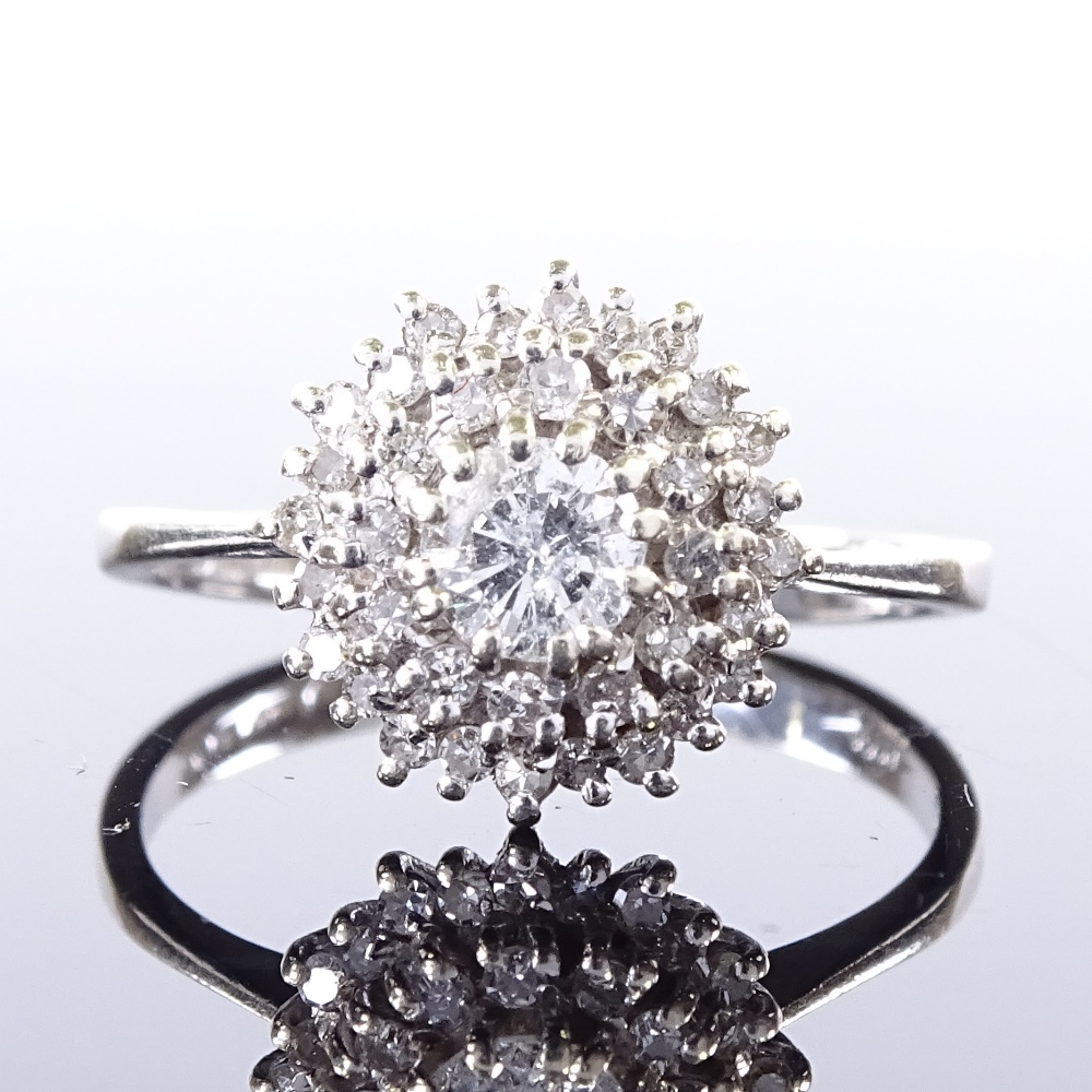 A 9ct white gold diamond cluster ring, central stone approx 0.3ct, maker's marks V&Co, hallmarks are