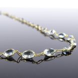 An unmarked gold aquamarine line necklace, necklace length 52cm, 6.4g very good original