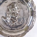 An Edwardian circular silver novelty ashtray, depicting the Artful Dodger, by Henry Greaves,