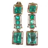 A pair of unmarked gold emerald line drop earrings, total emerald content approx 3.15ct, stud