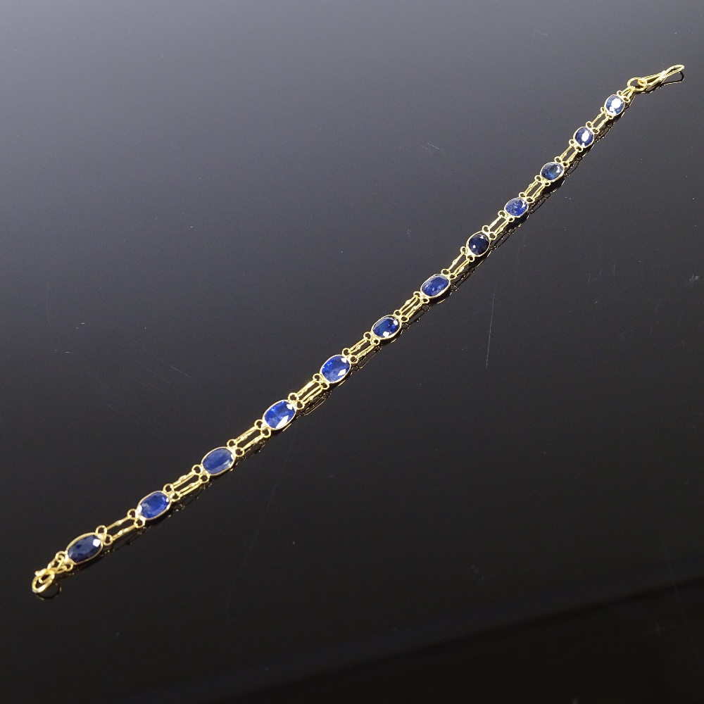 An unmarked gold oval-cut sapphire line bracelet, bracelet length 19cm, 2.3g Good original - Image 2 of 4