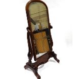 A Victorian mahogany cheval mirror with arched top, on carved and scroll supports