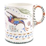 A Moorcroft Pottery pint mug with hand painted exotic birds and flowers, impressed Moorcroft marks