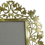 An Arts and Crafts pierced brass photo frame, height 21cm