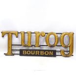 A Victorian giltwood letter advertising sign for Turog Bread, with wooden Bourbon sign below,