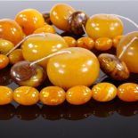 A graduated string of large simulated polished amber beads, largest bead length 39.8mm, and a string