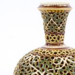 A Zsolnay reticulated porcelain narrow-necked vase with gilded highlights, height 11cm, diameter