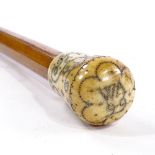 A 17th century ivory and pique-handled Malacca walking cane, handle inscribed WA99, handle height