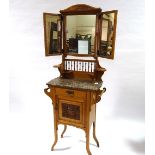 An Arts and Crafts light oak marble-topped wash stand, with mirror inset upper part