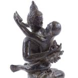 An Indian bronze figure of Buddha holding a child, height 17cm