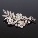 A Victorian unmarked gold diamond floral spray brooch, total diamond content approx 1ct, brooch