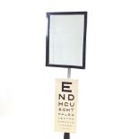An Art Deco Optician's mirror, ebonised wood frame mounted on adjustable chrome column and cast-iron