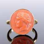 A silver-gilt relief carved coral panel ring, depicting Classical portrait, setting height 15.1mm,