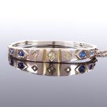 A Victorian unmarked gold sapphire and diamond hinged bangle, floral engraved bridge, total