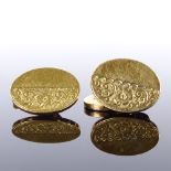 A pair of Victorian 18ct gold oval panel cufflinks, half-engraved floral decoration, indistinct