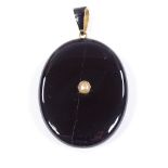A Victorian unmarked gold black enamel split-pearl and onyx locket memorial pendant, with vacant