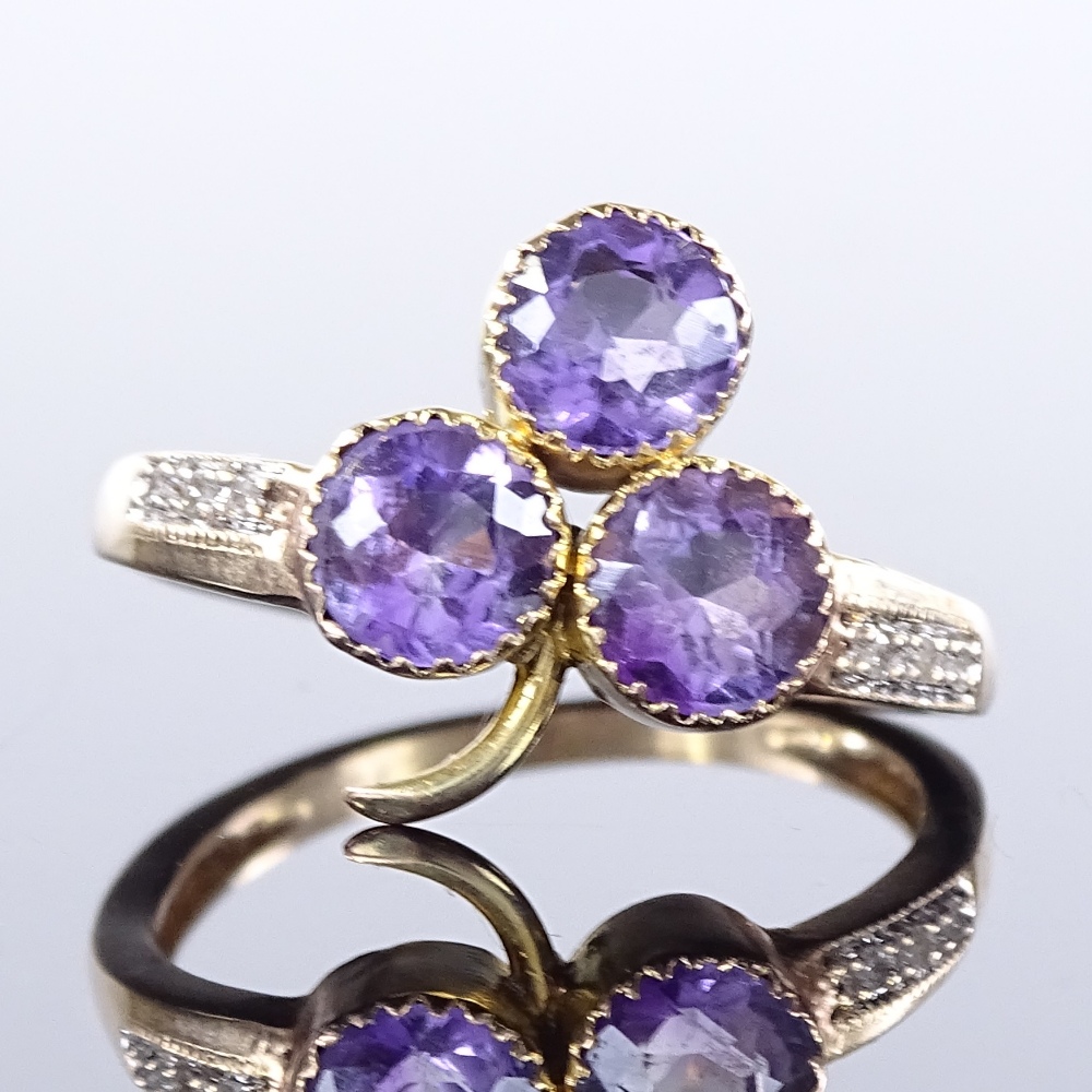 A 9ct gold amethyst 3-leaf clover ring, diamond set shoulders, setting height 13mm, size J, 1.8g