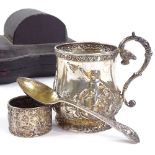 An Edwardian silver 3-piece eating set, comprising half pint mug, spoon and napkin ring, high