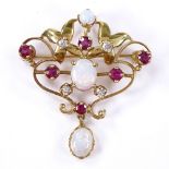 An Art Nouveau style 18ct gold opal, ruby and diamond pendant / brooch, pierced scrollwork settings,