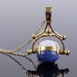 A 9ct gold cabochon stone set swivel fob pendant, on 9ct trace chain, fob height 21.5mm, chain