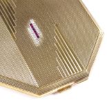 An Art Deco 9ct gold octagonal lady's compact, lid set with rows of calibre-cut rubies and round-cut