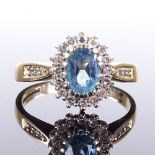 A 9ct gold blue topaz and diamond cluster ring, diamond set shoulders, setting height 11.8mm, size