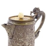 A Chinese mixed metal lidded jug with dragon handle and relief decorated sides, height to rim 11cm