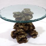 An Italian carved giltwood centre table, with naturalistic base and heavy glass top, 80cm across