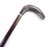 A horn walking cane with silver collar and hardwood shaft