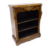 A 19th century walnut open bookcase of small size, with shaped top, floral marquetry inlaid frieze