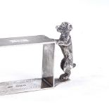 A George V novelty silver standing dog rectangular napkin ring, engine turned decoration, by Sanders