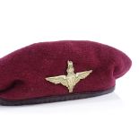 A red beret and badge, military style 1944 Period
