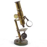 A brass student's microscope, circa 1900, height 24cm