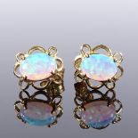A pair of unmarked gold cabochon opal earrings, pierced flower style settings, stud fittings,