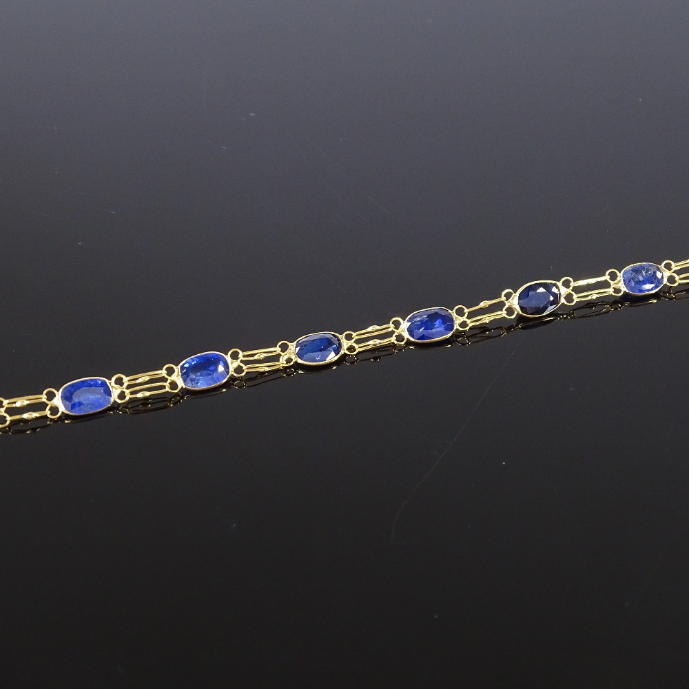 An unmarked gold oval-cut sapphire line bracelet, bracelet length 19cm, 2.3g Good original